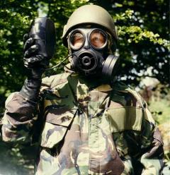 Soldier using a special drinking bottle with an Avon FM12 NBC respirator
