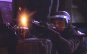 A Babylon-5 crewman fires his PPG at a Vorlon